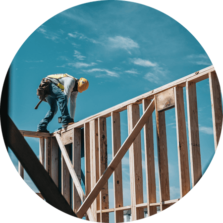 Man standing on timber construction beams